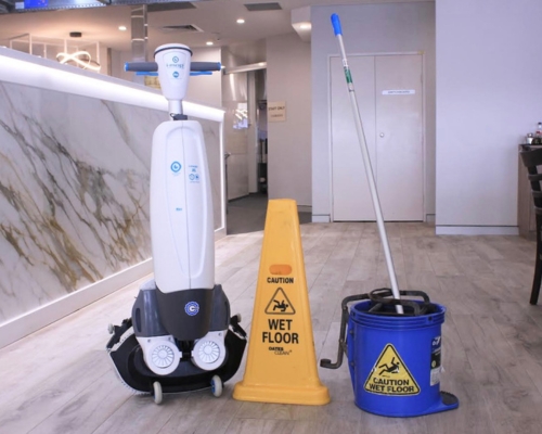 ROI mop vs i-mop i-mop floor scrubber with a caution wet floor sign and mop and bucket