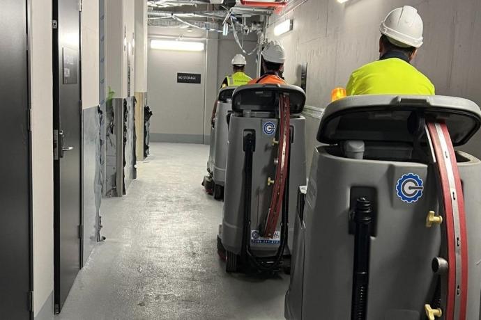 Cleaning equipment and operators maintaining airside service corridors in an aviation facility